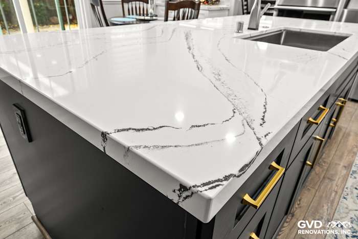 Close-up of Cambria custom quartz countertop with elegant veining and modern black cabinets in Roseville kitchen remodel