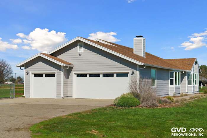 Modern home exterior in Galt featuring Pearl Gray James Hardie siding and Arctic White trim with Anlin windows