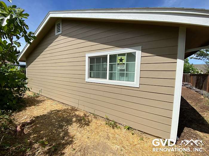 Newly installed James Hardie lap siding in Khaki Brown with Arctic White trim on Fairfield home exterior