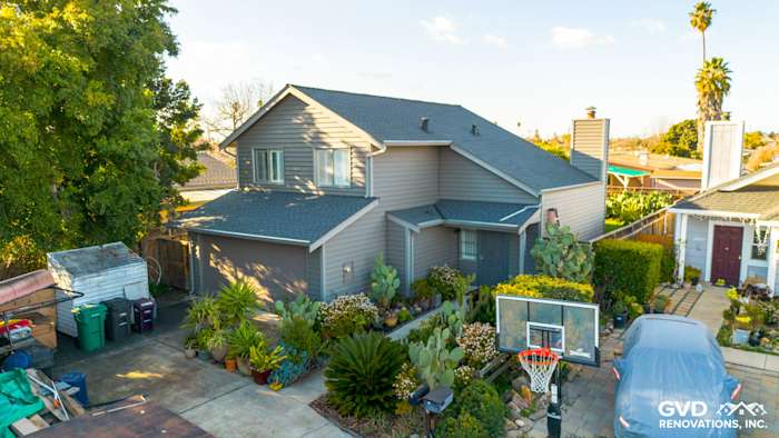 Updated home exterior featuring Ageless Slate Alside Prodigy Vinyl siding in Hayward, CA, with landscaped yard