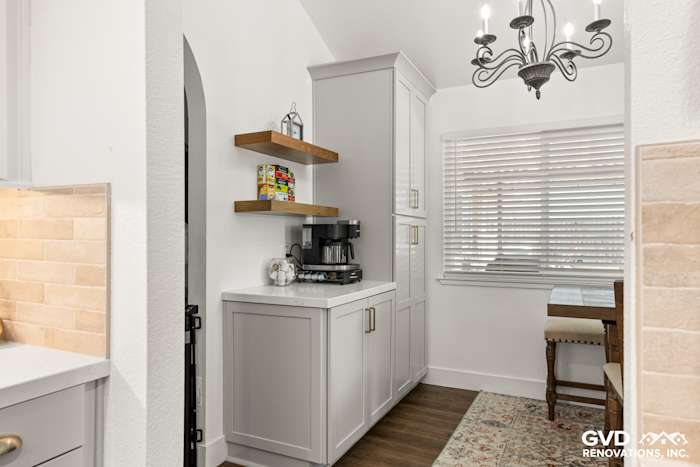 Modern kitchen remodel in Roseville featuring Waypoint cabinetry, floating shelves, and MSI Brickstone Ivory backsplash