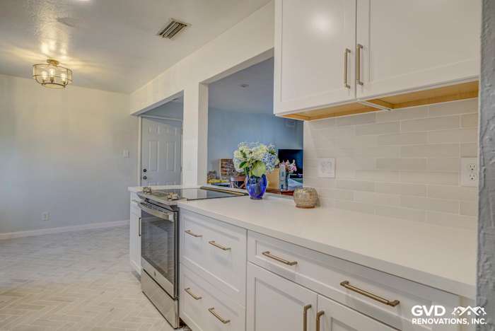 Bright, renovated kitchen featuring white cabinetry, quartz countertops, and modern pendant lights in Fair Oaks, CA