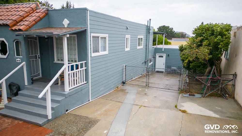 Home exterior featuring Boothbay Blue HardiePlank siding and Arctic White trim in Brisbane, CA