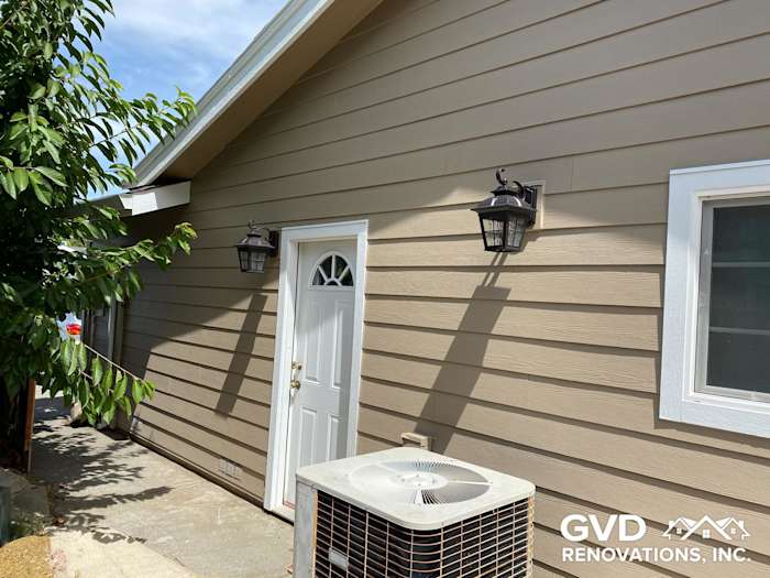 New khaki brown James Hardie lap siding with Arctic white trim on Fairfield home exterior