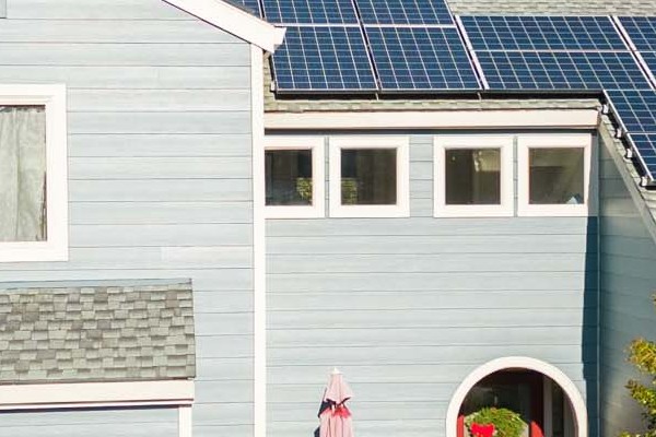 Home exterior featuring James Hardie Boothbay Blue siding, solar panels, landscaped front yard in Davis, CA