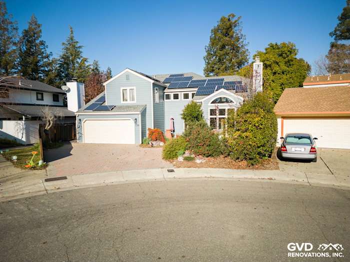 Home exterior featuring new Boothbay Blue James Hardie siding, solar panels, landscaped front yard in Davis, CA
