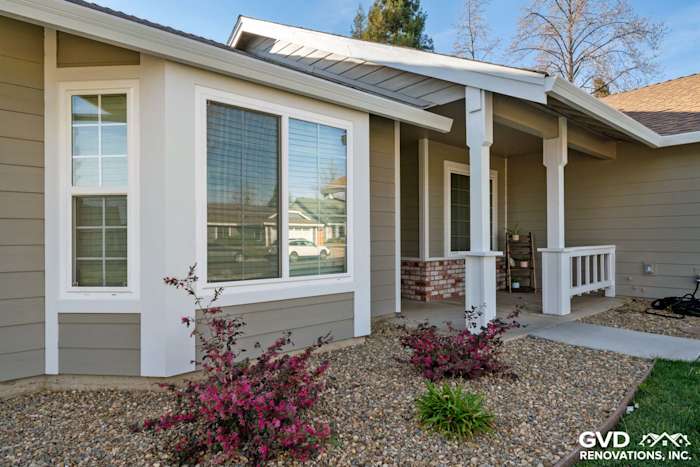 Monterey Taupe HardiePlank siding, Arctic White trim, and landscaped entrance in Folsom, CA