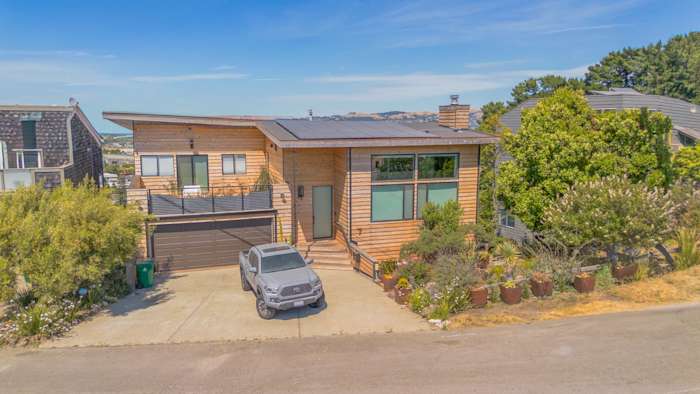 Natural cedar beveled plank siding on a modern home exterior with new deck railing in Richmond, CA