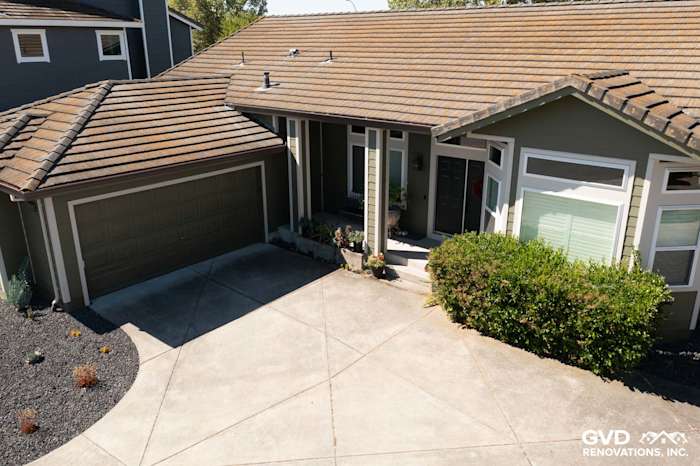 Petaluma home with Mountain Sage James Hardie siding and Cobble Stone trim, new garage door, and landscaped entryway