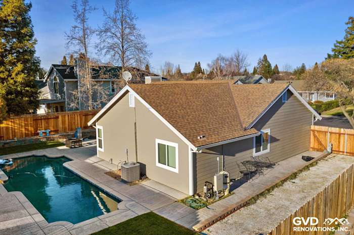 Folsom exterior renovation showcasing Monterey Taupe HardiePlank siding and Arctic White trim near a pool