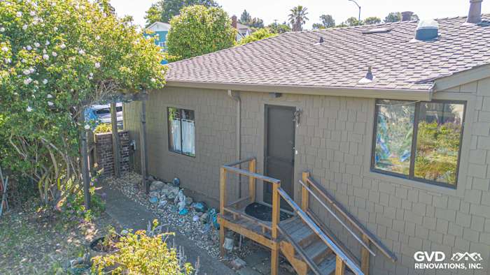 Home exterior featuring James Hardie Shake siding in a custom color, surrounded by landscaping and entryway steps