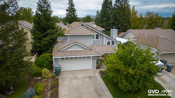 Home exterior in Rocklin featuring James Hardie Pearl Gray siding and Arctic White trim, surrounded by greenery