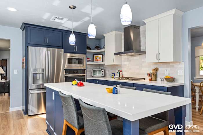 Modern kitchen remodel in Fair Oaks featuring navy cabinetry, white quartz island, and pendant lighting