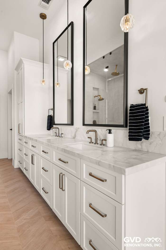 Luxurious bathroom vanity with marble countertop, double sinks, modern lighting, and stylish mirrors in El Dorado Hills