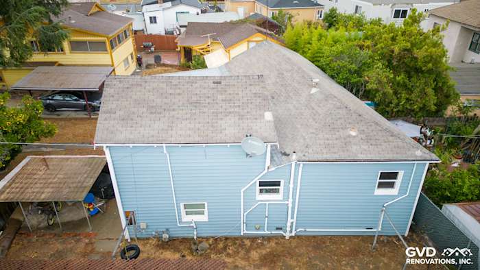 Aerial view of a house in Oakland featuring new blue Alside Prodigy Vinyl Siding and updated windows