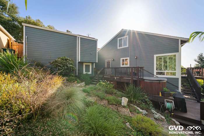 Modern home exterior with James Hardie lap siding, new windows, and landscaped yard in Oakland, CA