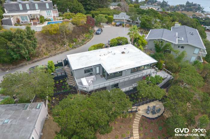 Modern home in San Rafael with T1-11 siding, new windows, and landscaped garden visible from above