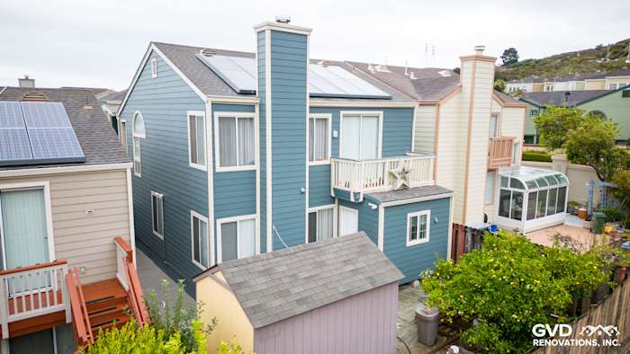 Evening Blue HardiePlank lap siding on a unique two-story home in Daly City, CA, with solar panels and balcony