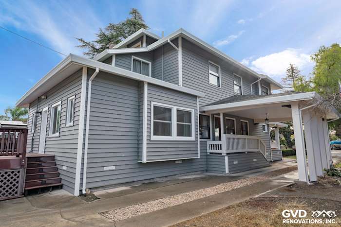 Home exterior featuring grey vinyl siding renovation with a porch, located in Dixon, CA
