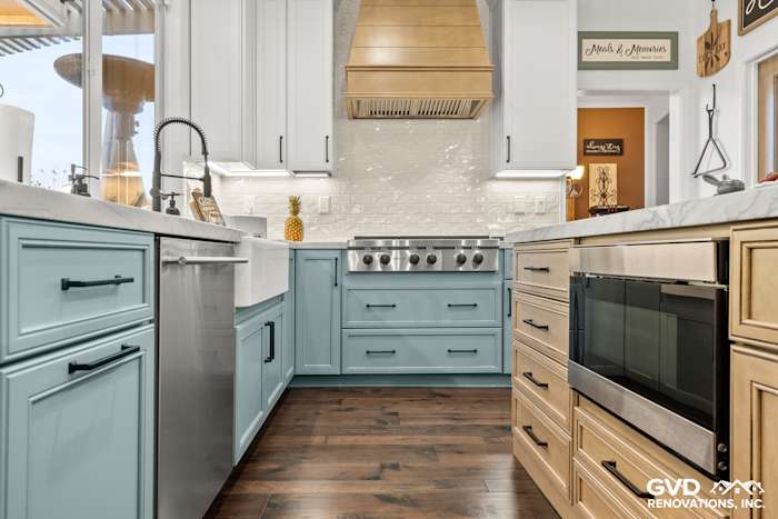 Modern kitchen remodel featuring blue base cabinets, quartzite countertops, and stainless steel appliances in Roseville, CA