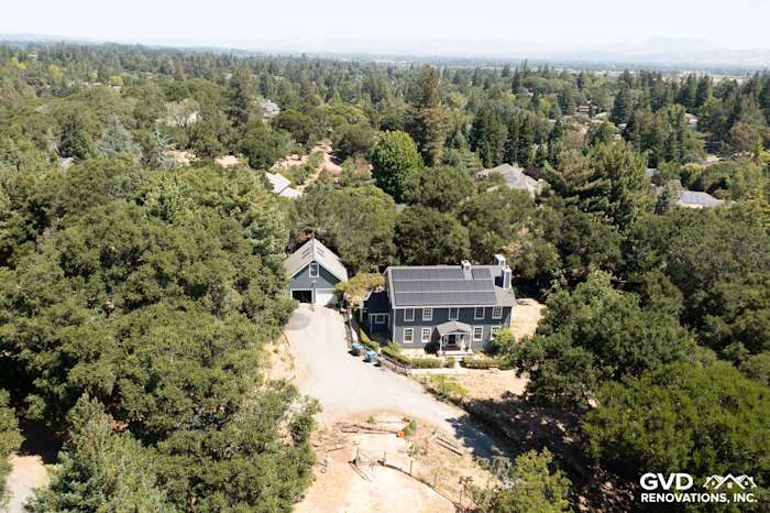 Aerial view of a house in Sebastopol featuring Evening Blue James Hardie siding and Arctic White trim among lush trees