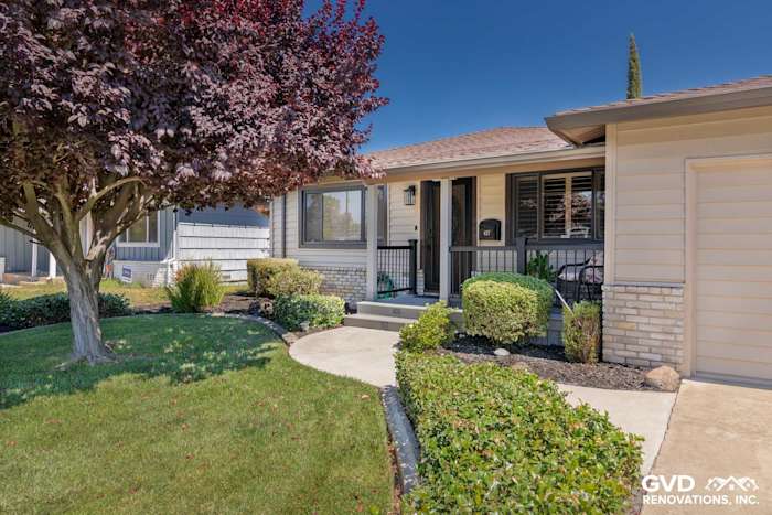 New Alside Prodigy vinyl siding and gutters on a home exterior with landscaped front yard in Rio Linda