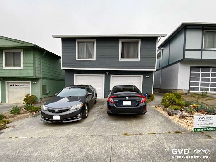 Modern home exterior featuring newly installed blue James Hardie siding in Daly City, CA, with parked cars