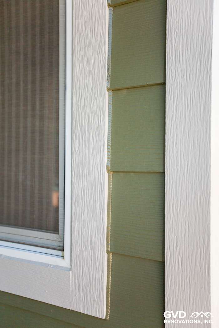 Close-up of James Hardie fiber cement siding in green with white trim near a window in Pleasanton, CA