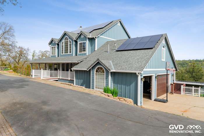 Newly installed James Hardie siding on a blue home in Shingle Springs, featuring a modern roof and solar panels