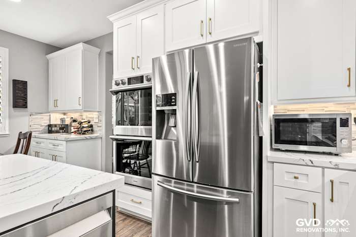 Modern kitchen with Cambria quartz countertops, stainless steel appliances, and custom white cabinets in Roseville remodel
