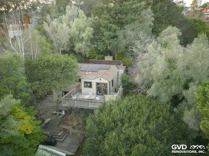 Oakland home featuring Khaki Brown James Hardie siding, Timber Bark trim, and Marvin windows amidst lush greenery