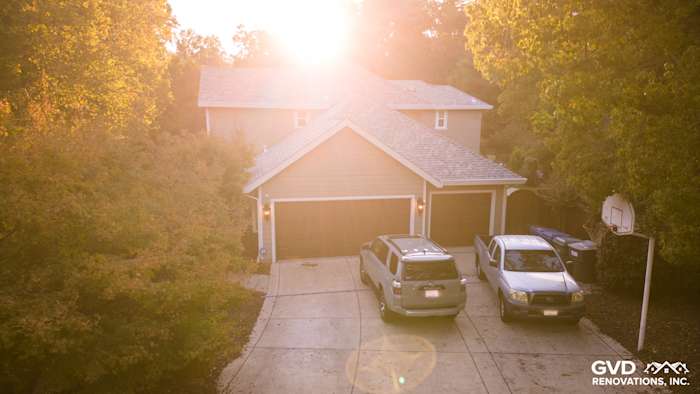 Home exterior featuring new James Hardie Cedarmill siding in Monterey Taupe and Arctic White trim, sunlit driveway