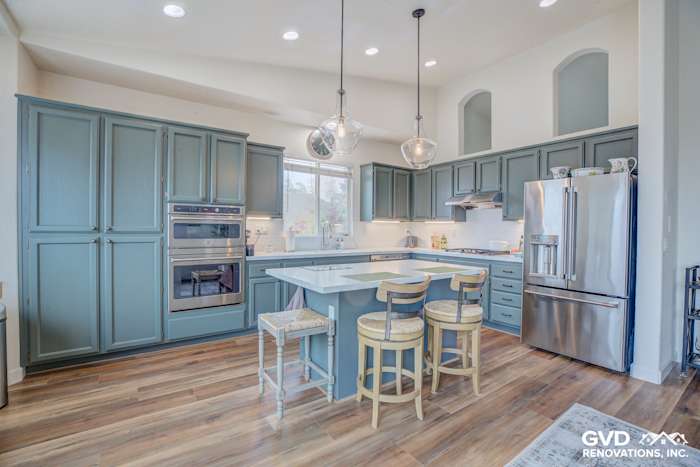 Modern kitchen remodel in El Dorado Hills with blue cabinets, quartz island, and stainless steel appliances