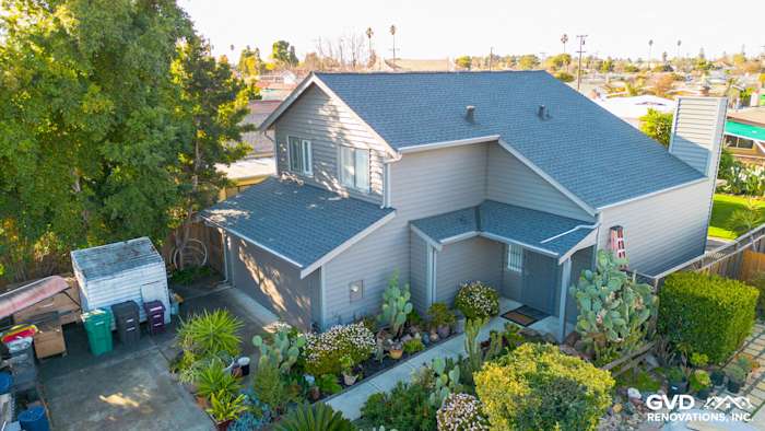 Home exterior featuring Alside Prodigy Vinyl siding in Ageless Slate color, landscaped yard, and modern architecture