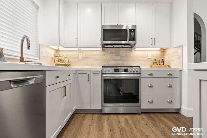 Modern kitchen remodel in Roseville featuring Waypoint cabinetry, Vadara Naurelle stone countertop, and MSI Brickstone Ivory