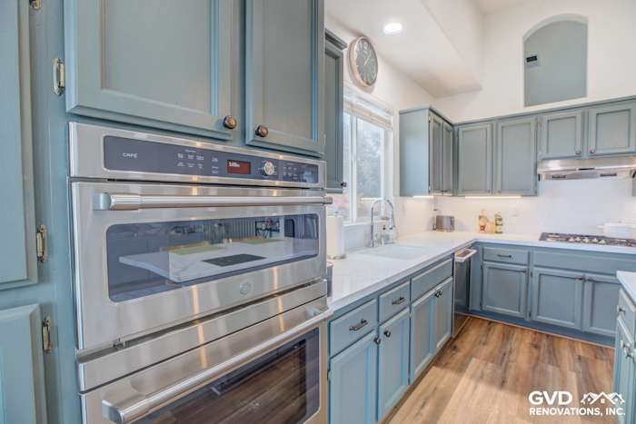 Stylish kitchen remodel featuring blue cabinetry, stainless steel appliances, and quartz countertops in El Dorado Hills