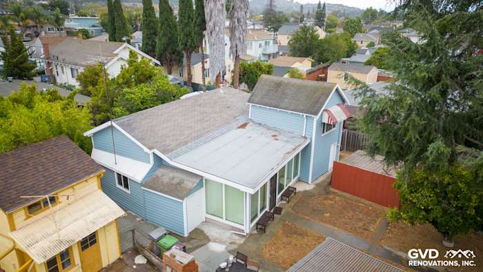 Aerial view of home exterior with new Alside Prodigy vinyl siding in blue, showcasing upgraded windows and landscape