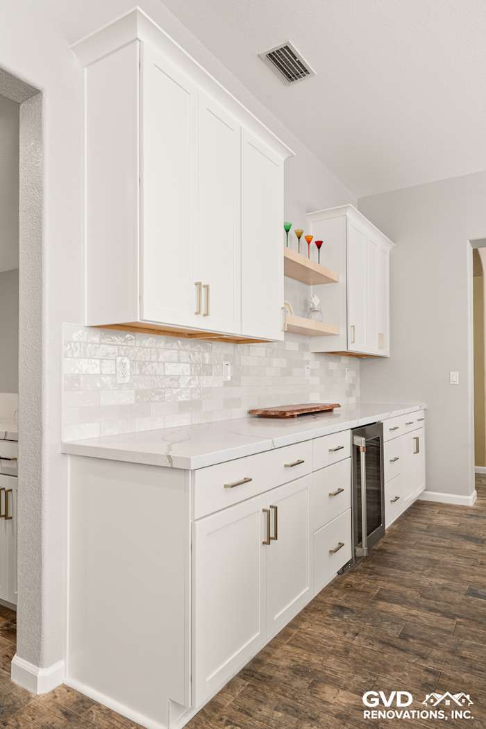 Modern kitchen featuring white Diamond cabinets, MSI countertops, and a stylish full-height backsplash in Roseville, CA