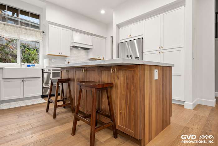 Modern kitchen in Folsom featuring Waypoint cabinets, Fieldstone island, and custom Vadara Bronzo countertops