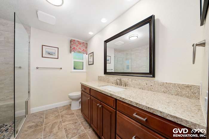 Modern bathroom with granite countertop, wooden vanity, and stylish mirror in Fair Oaks renovation