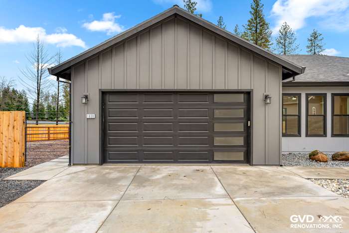 Modern home exterior in Paradise featuring James Hardie siding, Milgard black windows, and a sleek gray garage door