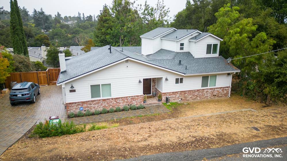 Stylish remodeled home featuring modern white siding, new windows, and landscaped front yard