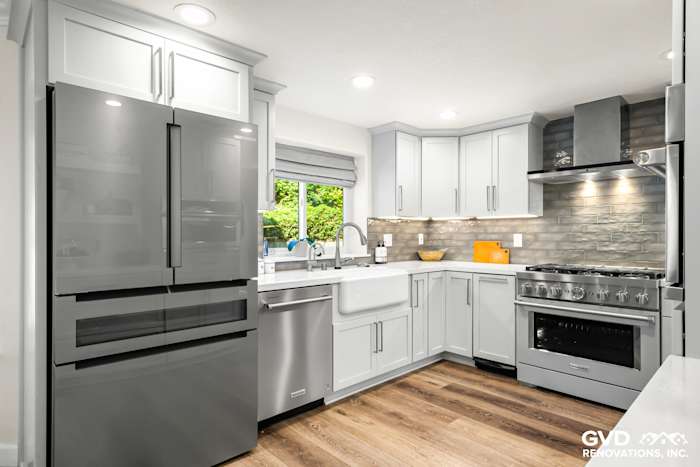 Modern Rocklin kitchen remodel features sleek gray cabinets, stainless steel appliances, and bright backsplash tile