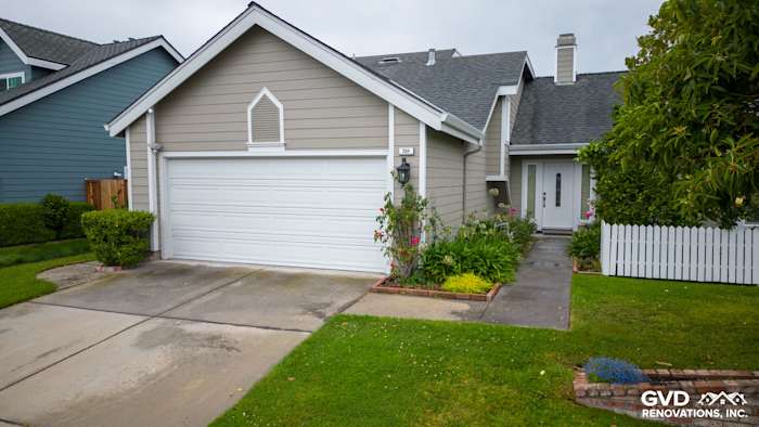 Home exterior renovated with James Hardie Monterey Taupe siding, Milgard windows, and white trim in Foster City