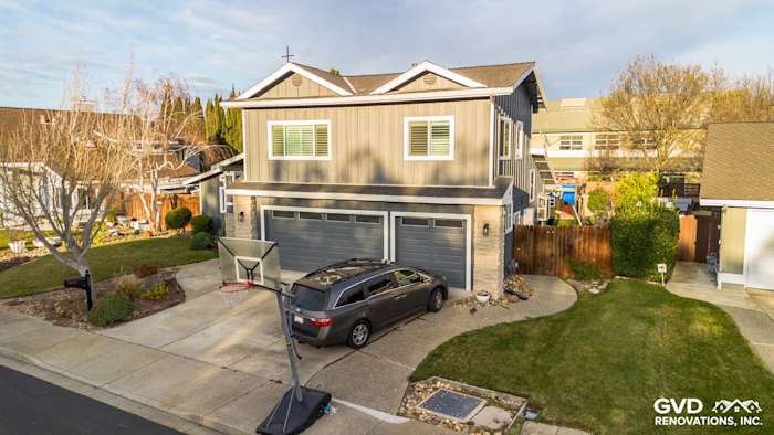 Two-story home exterior in Dublin, CA, featuring new Night Gray James Hardie siding and Arctic White trim