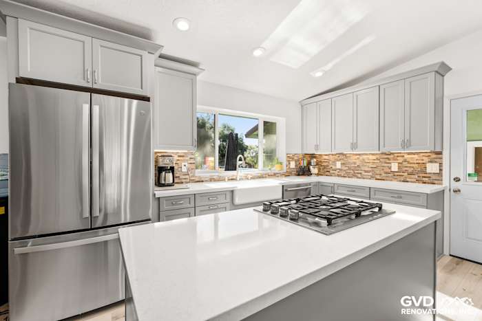 Modern kitchen remodel featuring gray cabinetry, stainless steel appliances, and quartz countertops in Greenwood, CA