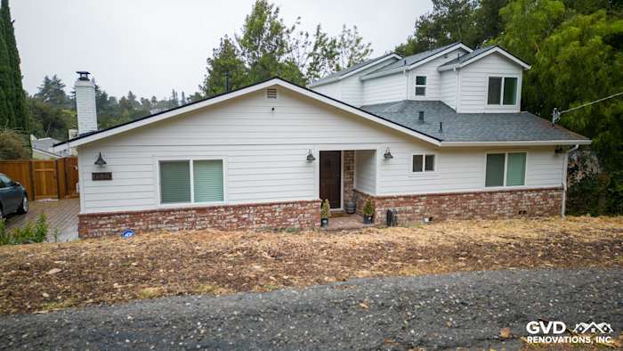 Modern home exterior in Oakland featuring James Hardie Cedarmill siding, Alside windows, and brick detailing