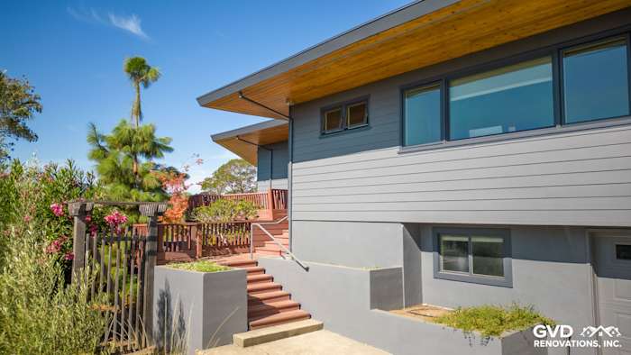 Modern home exterior featuring James Hardie Plank Lap Siding in Night Gray with wood accents and landscaped yard