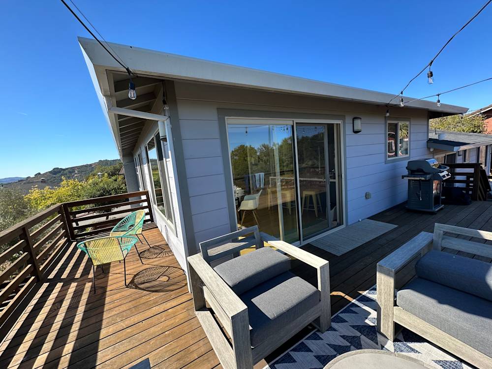 Outdoor deck with wooden flooring and modern furniture, featuring expansive views in Northern California