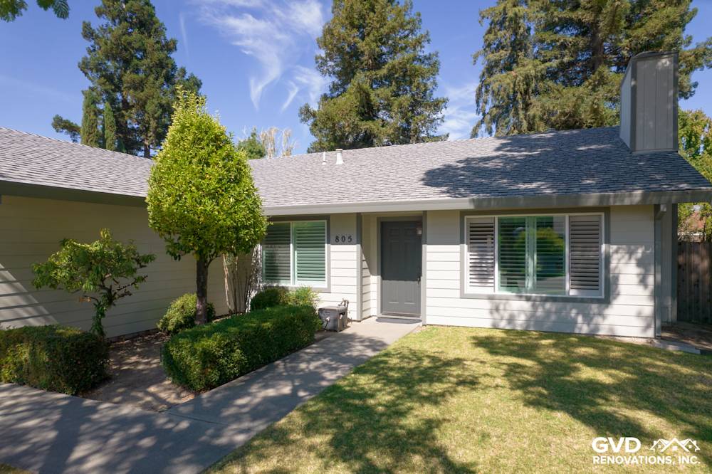 Modern Sacramento home exterior with James Hardie Siding, Anlin Catalina Windows, and lush green landscaping